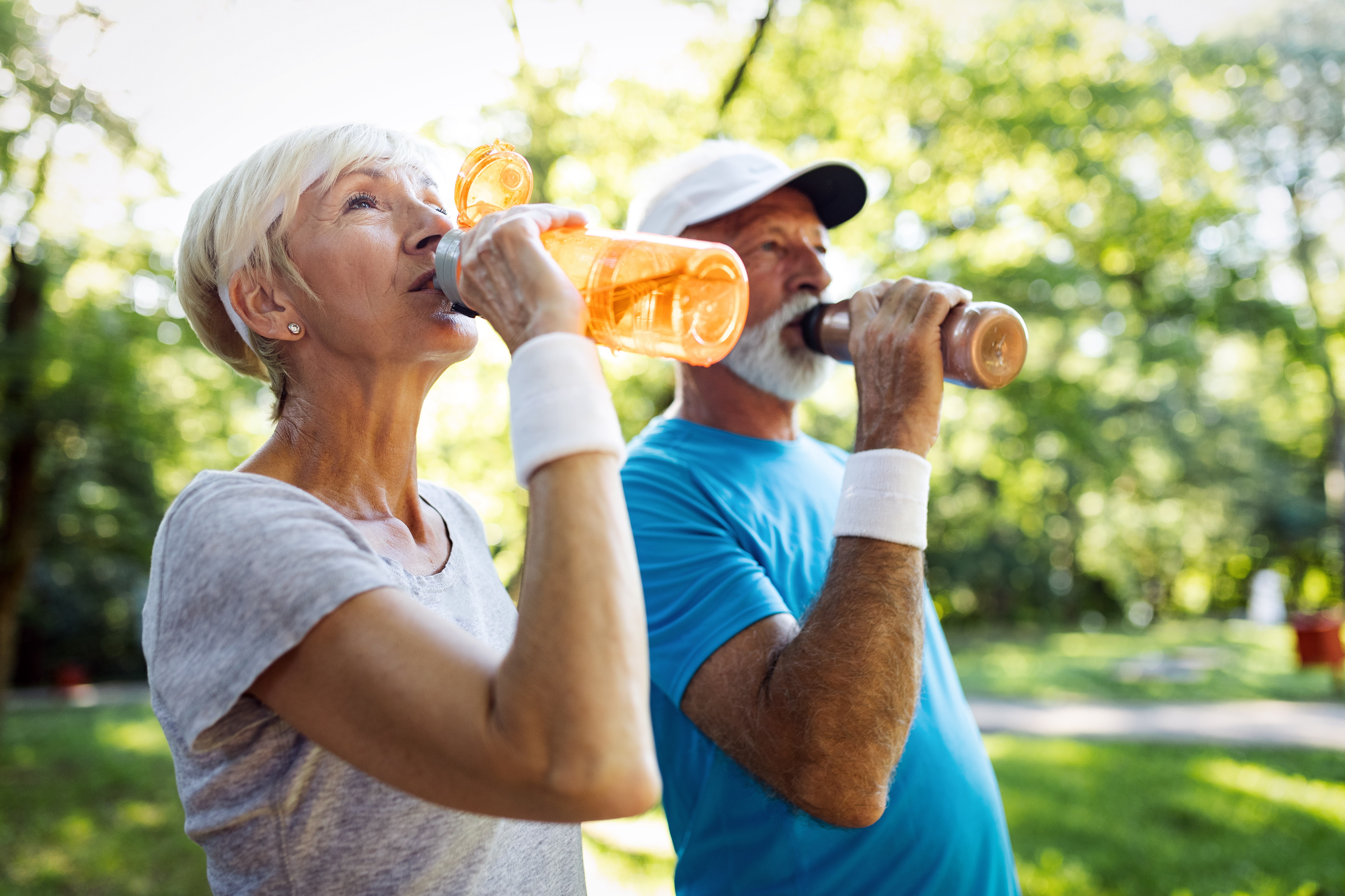 Senior couple staying hydrated after running jogging