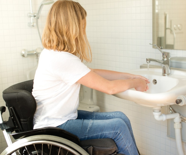 Person in a wheelchair washing hands